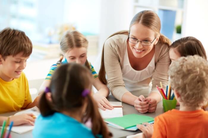 happy-teacher-listening-to-her-students (1).jpg